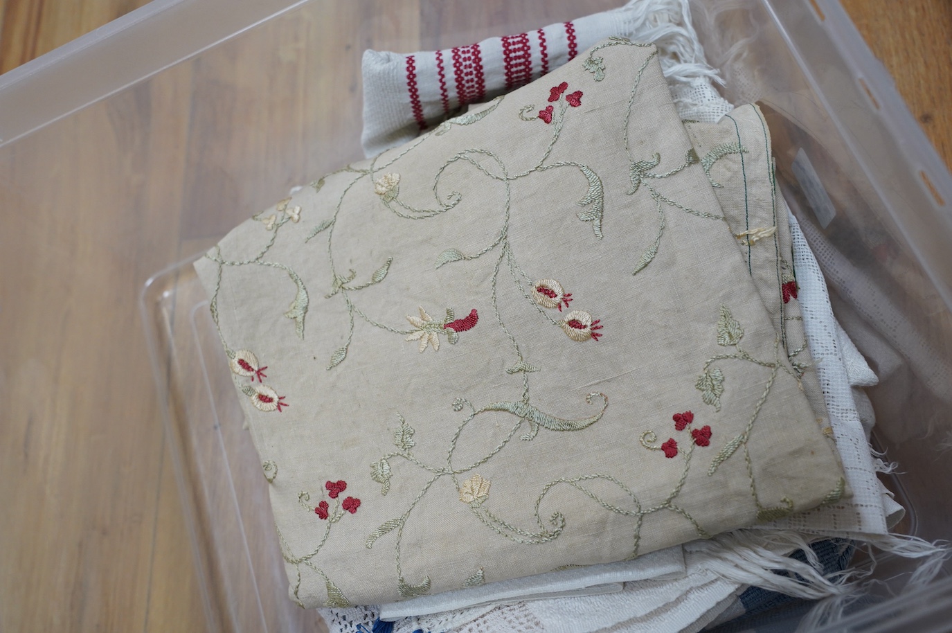 A 19th century embroidery on linen, a decorative hand towel in blue cross stitch, a finely worked table centre and a collection of handkerchiefs, etc. Condition - fair